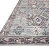 Side angle showing thin low-pile texture and stitched edges of Zion Grey / Multi Rug.