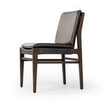 Detailed view of black leather upholstery and cushioned seat integrated with wood frame