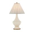 Ivory pleated fabric lampshade with brass finial, close-up showing texture and light
