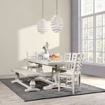 Dining room setup featuring the table with matching chairs and bench on a dark textured rug