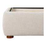 Curved corner upholstery and wooden leg detail on Luzon bed frame