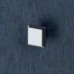 Close-up detail of square metal knob on top drawer of navy blue side table