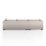 Rear view of sectional from angle showing gap between two modular pieces and visible feet