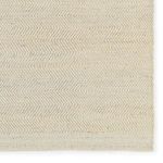 Detail of one rug corner highlighting the chevron woven border design