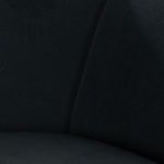 Close-up of curved velvet arm and smooth seat cushions on sofa