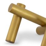 Detail highlighting the rounded ends and smooth texture of the golden cylinders from a side angle
