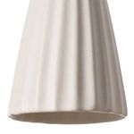 Close-up of scalloped bottom edge and reeded texture on ceramic shade of Wilma Sconce