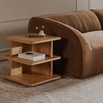 Casey side table placed next to curved brown sofa on beige carpet in living room setting