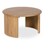 Side angle showing fluted details wrapping around one leg of the round oak coffee table