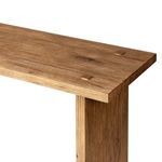 Close-up of the table edge showing wood grain and joining pegs in natural oak finish
