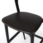 Close-up of black leather seat surface with smooth texture