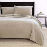Taupe cotton Amsterdam Coverlet styled on a king-sized bed with pillow shams in a modern bedroom setting