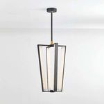 Edgemere Pendant lit with warm LED light, suspended against white wall