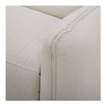 Close-up on soft beige fabric texture and detailed seam stitching on sofa arm