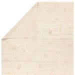 Top view of Eurydice rug with corner folded to reveal plain backing fabric