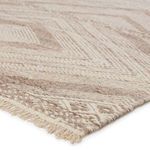Close-up on corner showing thick texture and short fringe detail in taupe and cream colors
