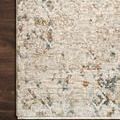 Close-up on rug corner showing fine texture, refined edging, and muted multicolor pattern on dark wood floor