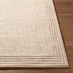 Detailed close-up of the rug’s layered border texture showing tight weave and wool fiber quality