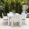 Outdoor dining scene with eight Newport Dining Chairs arranged around white slatted dining table