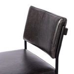 Close-up of Benton Stool backrest shows smooth black leather upholstery and metal support