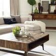 Side angle of sectional sofa in styled room with light tile flooring and large windows