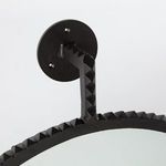 Side angled close-up of pyramid textured black frame and circular mount