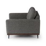 Side view showing chair armrest and straight back with fabric texture visible