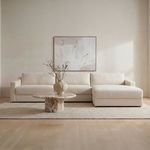 Styled living room scene with Farrow Sectional sofa, neutral rug, round coffee table, and abstract wall art