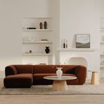 Zandro sectional styled in a modern living room with light walls, layered rug, and a round wooden coffee table