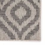 Detailed close-up of dark gray ikat pattern with visible woven fibers and subtle texture