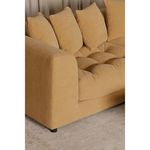 Close-up of camel-colored variant’s tufted seat cushions and loose back pillows on carpeted floor.