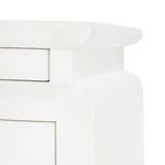 Close-up of upper side edge and drawer front revealing subtle linen texture on white lacquer finish