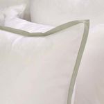 Close-up of pillow with seaglass green satin border trim on white bamboo sateen fabric