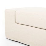 Overhead view focused on bench cushion and armrest intersection with seamless linen slipcover
