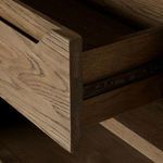 Close-up showing dovetail joint detail on an open wood drawer inside cabinet
