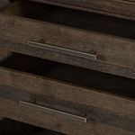Close-up on drawer handle and interior showing dark wood interior and metal handle finish