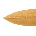 Side view highlighting textural cotton weave front with smooth fabric back on pillow