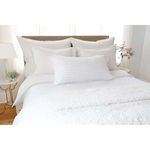 Bed with Blake white duvet, white pillows and long lumbar pillow in bright natural light