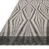 Low angle close-up showing the rug's raised textured weave and charcoal border detail