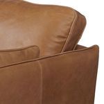 Close-up on leather texture and pencil welt piping on back and side cushions