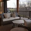Outdoor deck seating setup with Montauk sofa paired with matching pillows, black metal and wood tables