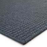 Indoor/outdoor area rug in solid deep blue with a braided textured polypropylene construction