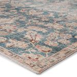 Bardia area rug featuring a distressed oriental Oushak design in dark teal and rosy rust with a meandering border