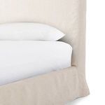 Straight-on close-up of headboard showing clean edges and smooth natural linen upholstery