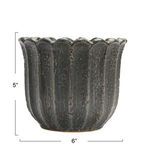 Grey and black 6 inch round stoneware planter shaped like a daisy flower with textured vertical ridges