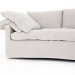 Partial view of one side of sofa displaying seat cushion depth and pillow softness