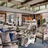 Indoor room setting featuring Laguna Sofa and armchairs around rustic wood coffee table on blue rug