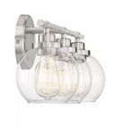 Side angle highlighting the circular backplate and exposed bottom of clear glass shades on satin nickel bath light
