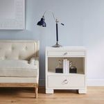 Frances side table styled next to cream upholstered settee with black adjustable reading lamp on top