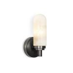 Side view of sconce illuminated, showing depth and texture of globe and backplate